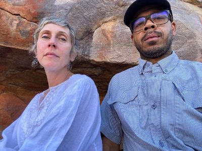 Both Nadia Farmiga and Wilson Costa is wearing a light blue themed clothes are posing with rocks in the background.